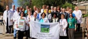 Temple University Hospital staff raise a Donate Life flag to honor organ and tissue donors during National Donate Life Month event.