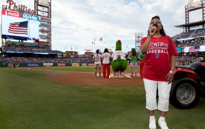 Arlinda sings at the Phillies game. 