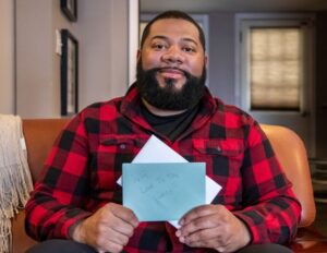 Man holds a letter in his hands.