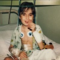 A child sits in a hospital bed.