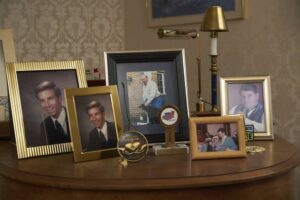 A group of pictures in frames sits on a table in a room.