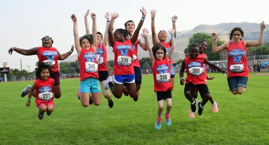 A group of kids jump into the air.