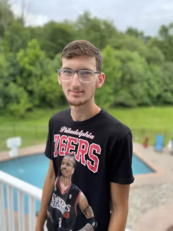 A young man poses for a photo.