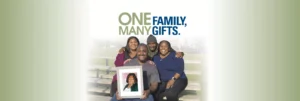 Family members hold a photo of a loved one and pose for a picture.