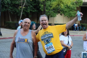 Two men pose for a picture during a race.