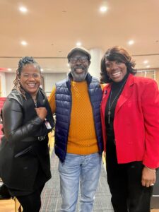Three people pose for a picture following an event.