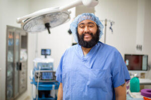 A healthcare worker smiles when posing for a picture.
