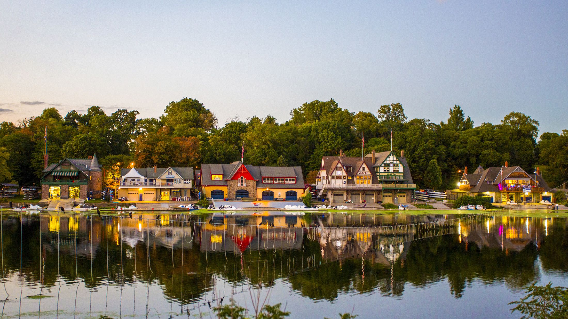 A row of 19th-century boathouses line the Schuylkill River just west of the Philadelphia Museum of Art. After dark, twinkling lights outline the structuresÕ roofs, windows and doors, reflecting on the water and inspiring passersby, including drivers along I-76 West, the Schuylkill Expressway.