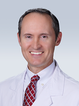 A doctor smiles for a photo.