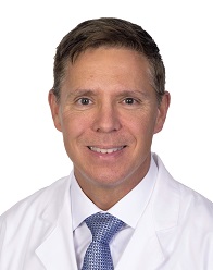 A doctor poses for a photo.