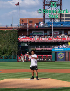 A teenager throws out the first pitch at a Philadelphia Phillies game.