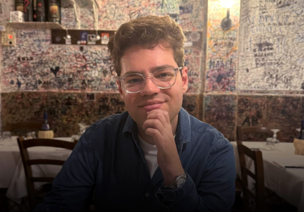 A man poses for a picture inside a restaurant.