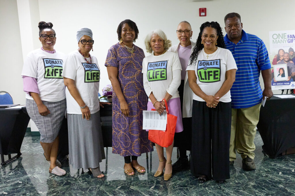 A group of men and women pose for a photo.
