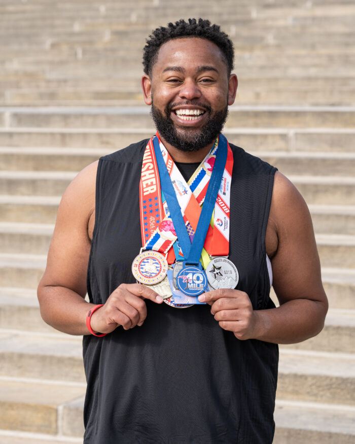 Heart and liver recipient Keath Gerald shows off his Transplant Games medals.