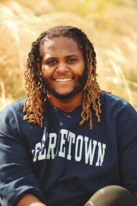 A man smiles for a posed picture.