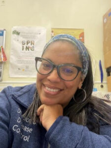 A woman smiles in a posed picture