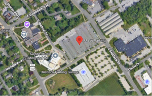 Aerial map showing the 'M Lot Parking' area at the intersection of S Walnut St and Norfolk Ave, with nearby Matlock Parking Garage and surrounding buildings.