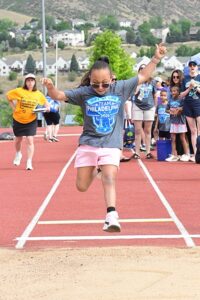 Pediatric transplant recipient Ariana competes in the long jump at the 2026 Transplant Games of America.