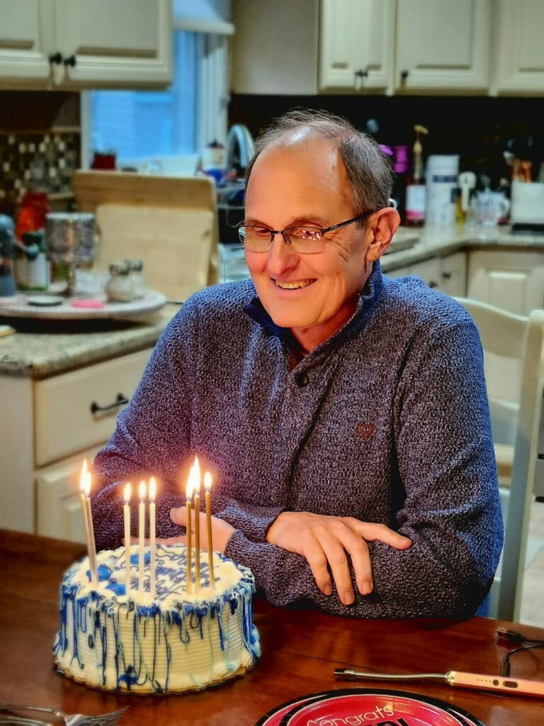 Tom celebrates his birthday with candles and cake.